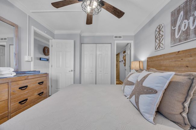 Bedroom with a closet, ornamental molding, and a ceiling fan | Image 6