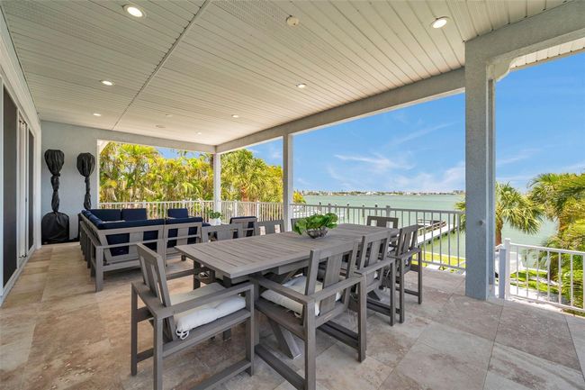 Huge covered 2nd story balcony with travertine tile. | Image 15