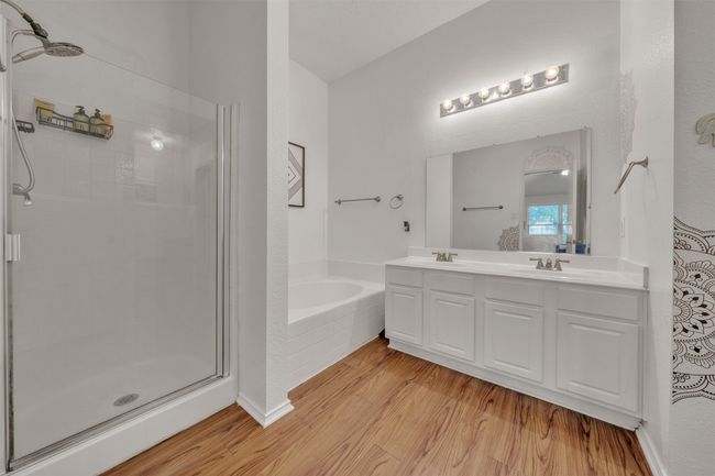 Full bath with a shower stall, a garden tub, wood finished floors, and double vanity | Image 12