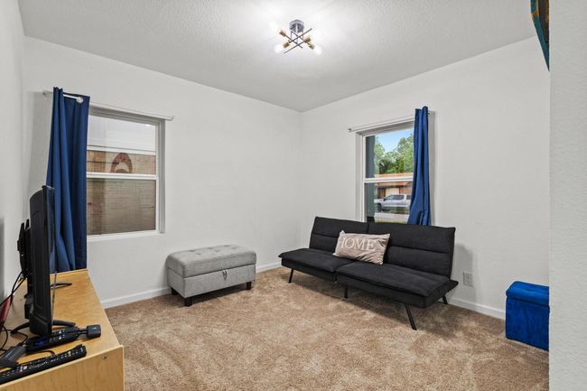 Sitting room with carpet flooring, baseboards, and a textured ceiling | Image 22