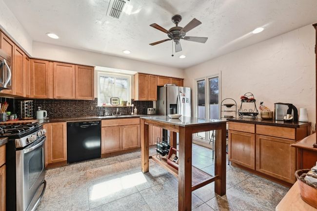 Well laid out, charming kitchen with plenty of cabinet space and stainless steel appliances. | Image 10