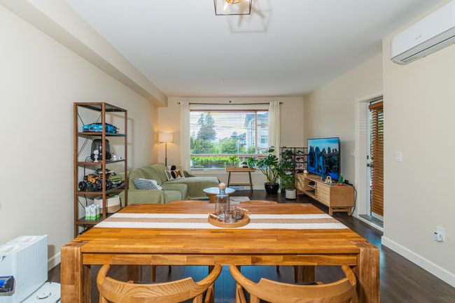 Dining room featuring a wall mounted AC, dark wood-type flooring, and baseboards | Image 11