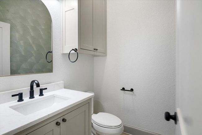 Bathroom featuring vanity and a textured wall | Image 16