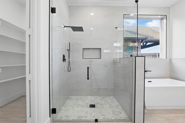 Full bath with a freestanding tub, a stall shower, and wood finished floors | Image 34