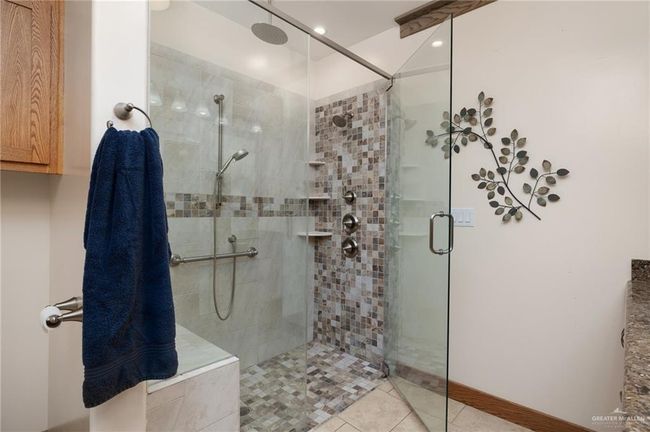 Bathroom with tile patterned floors and a shower with door | Image 18