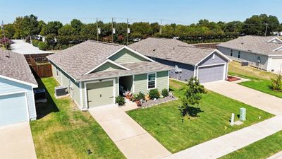 Single story home with an outdoor structure, a garage, and central AC | Image 2