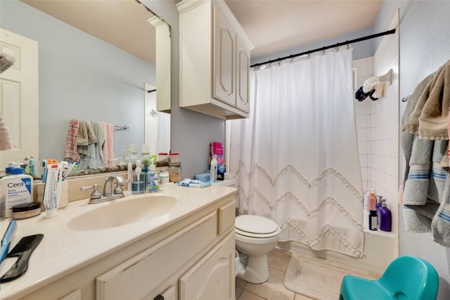 Bathroom with vanity, tile patterned floors, and shower / bath combination with curtain | Image 25