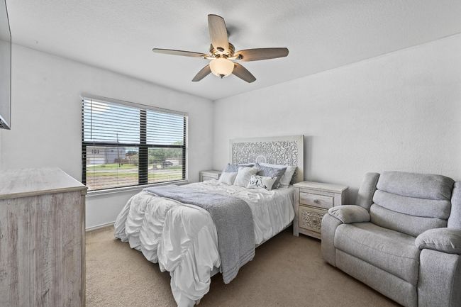Bedroom with light carpet and ceiling fan | Image 29