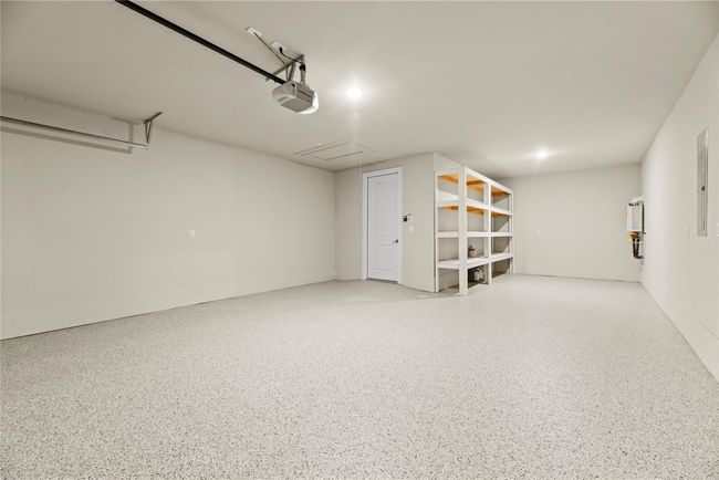 The spacious 3-car tandem garage features an automatic garage door opener, built-in shelving for added storage, and a clean epoxy floor finish. This home is also packed with energy-efficient features, including ceiling fans, a digital programmable thermostat, Energy Star appliances and lighting, high-efficiency HVAC (13+ SEER), spray foam insulation, insulated Low-E windows, and a tankless on-demand water heater designed to keep you comfortable while saving on utility costs. | Image 41