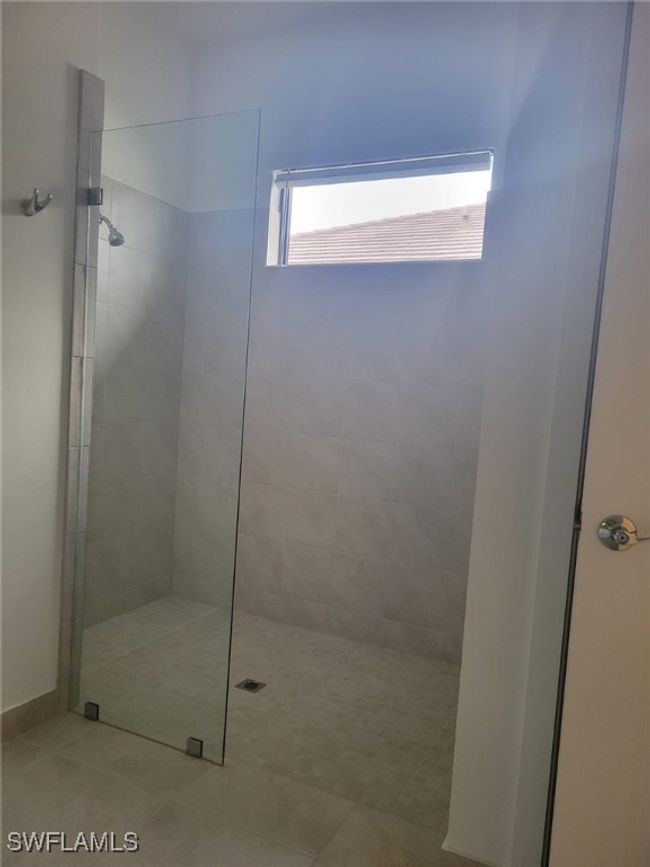 Bathroom featuring a walk in shower and tile patterned floors | Image 14