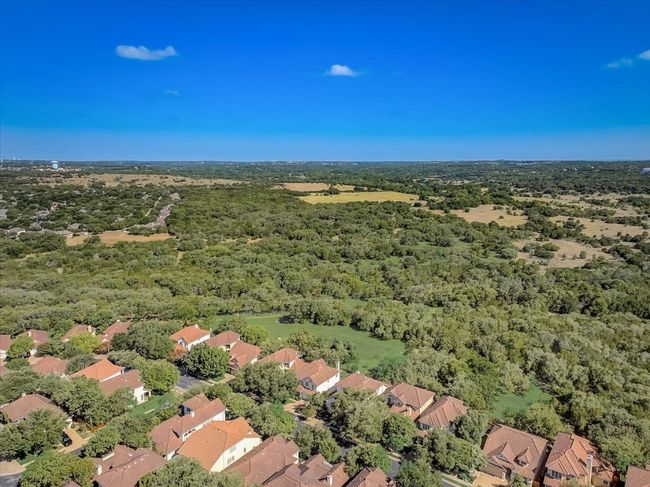 Aerial overview of property's location with a heavily wooded area and nearby suburban area | Image 30