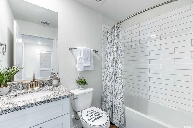 Bathroom featuring vanity and shower / bath combo with shower curtain | Image 20