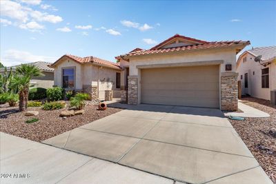 The home features beautiful stacked stone at the front and accented on the garage. | Image 3