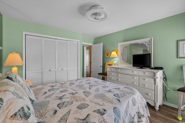 Primary Bedroom with dark wood finished floors, baseboards, and a closet | Image 23