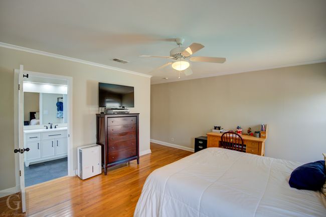 Bedroom featuring baseboards, visible vents, ceiling fan, crown molding, and light wood-type flooring | Image 18
