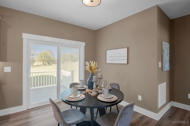 Dining room featuring visible vents, baseboards, and wood finished floors | Image 7
