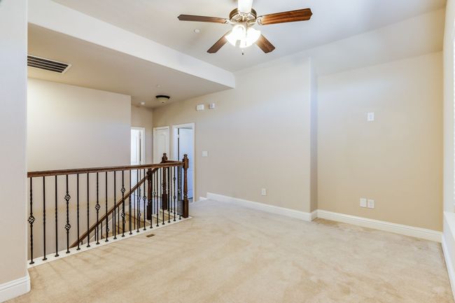 Carpeted spare room featuring baseboards and a ceiling fan | Image 22
