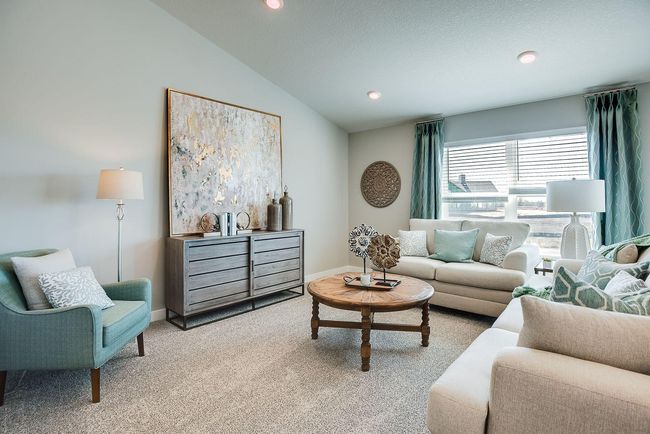 Although this living room photo does not show the electric fireplace, this home is planned for a gorgeous electric fireplace that can be used both aesthetically and for additional heat! Photo of model home, colors and selections shown may vary | Image 8