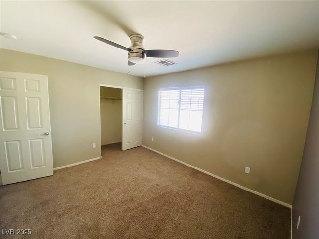 Unfurnished bedroom with a ceiling fan, visible vents, baseboards, carpet floors, and a closet | Image 23