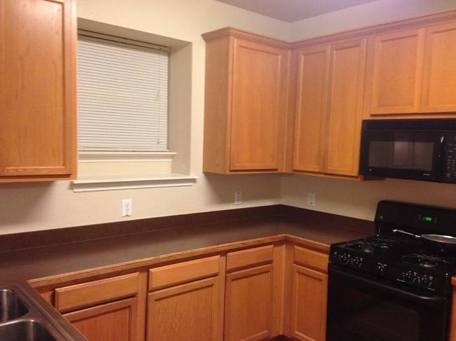 Kitchen with black appliances and dark countertops | Image 5