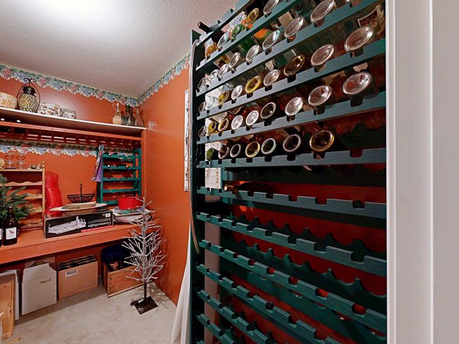 Wine cellar with a textured ceiling and carpet | Image 35