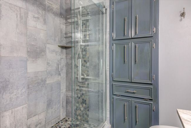 Bathroom with a stall shower and toilet | Image 12