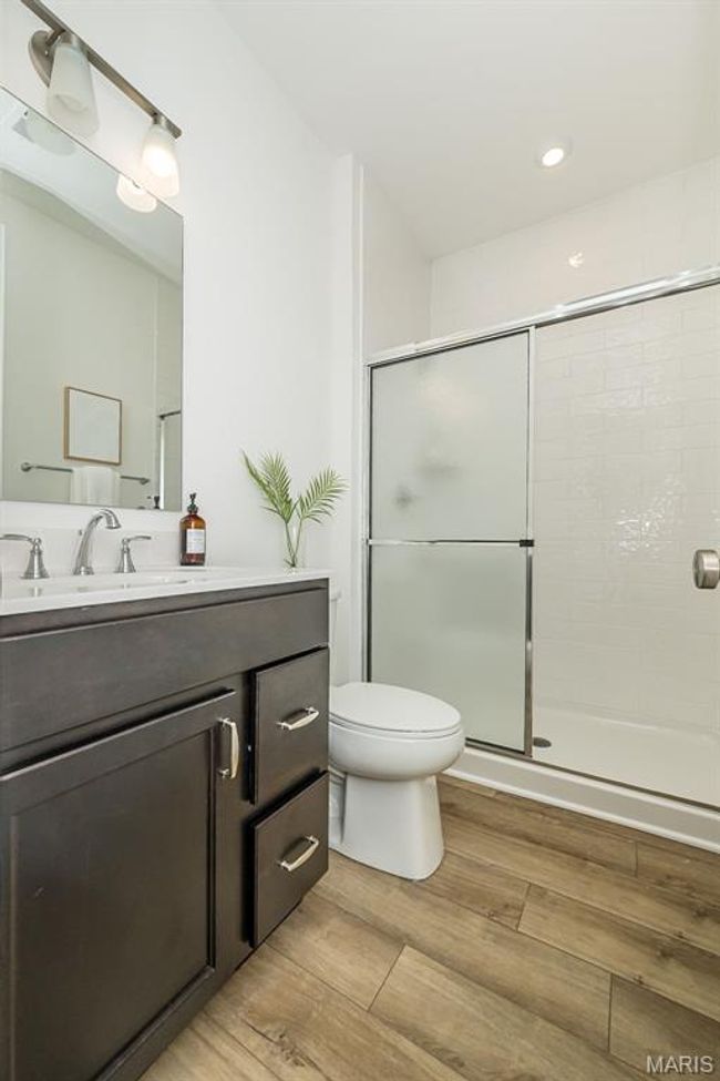 Bathroom with a shower stall, vanity, wood finished floors, and recessed lighting | Image 35