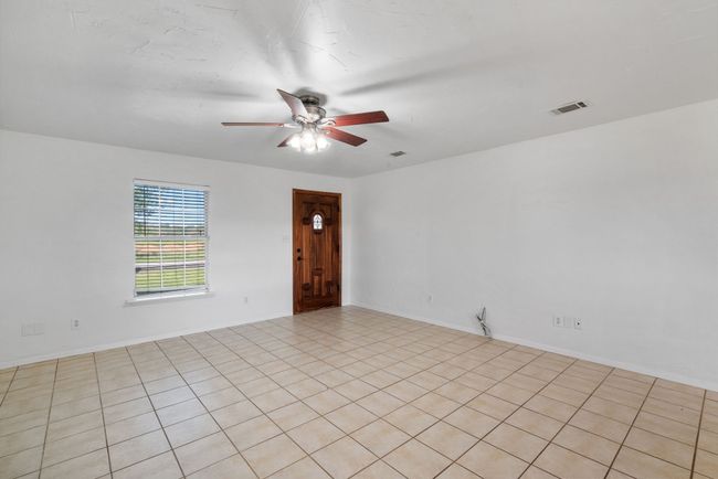 Empty room featuring a ceiling fan | Image 14
