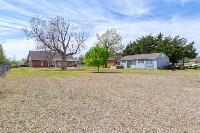 View of yard featuring an outdoor structure and fence | Image 4