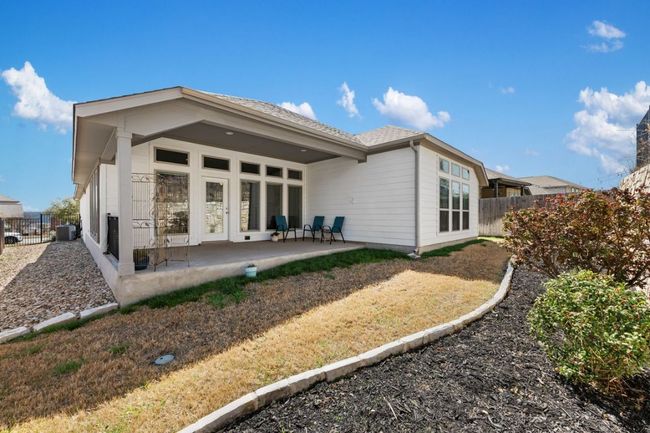 Back of property with central air condition unit, a patio, and fence | Image 30