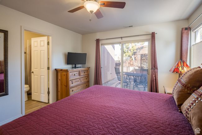 Bedroom featuring ceiling fan, access to exterior, and ensuite bath | Image 21