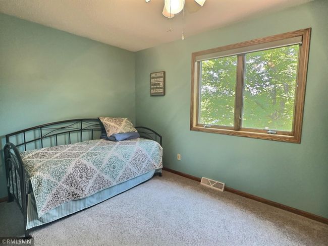 This bedroom has fantastic views of the lake. | Image 22