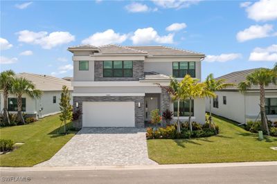 View of front of home featuring a garage and a front yard | Image 1