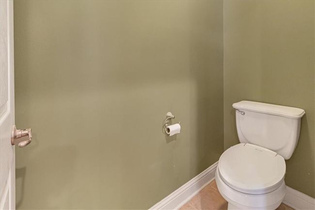 Bathroom featuring baseboards, tile patterned flooring, and toilet | Image 30