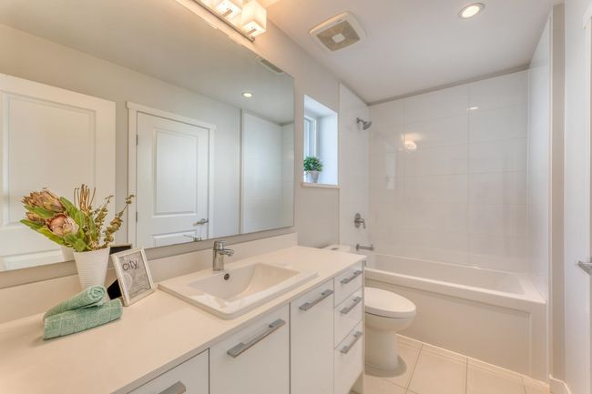 Full bath featuring vanity, bathing tub / shower combination, tile patterned floors, and recessed lighting | Image 26