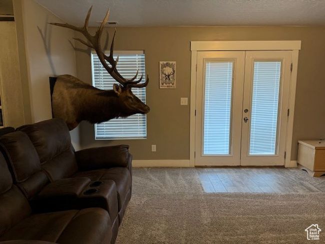 Doorway featuring carpet floors, a healthy amount of sunlight, baseboards, and french doors | Image 16