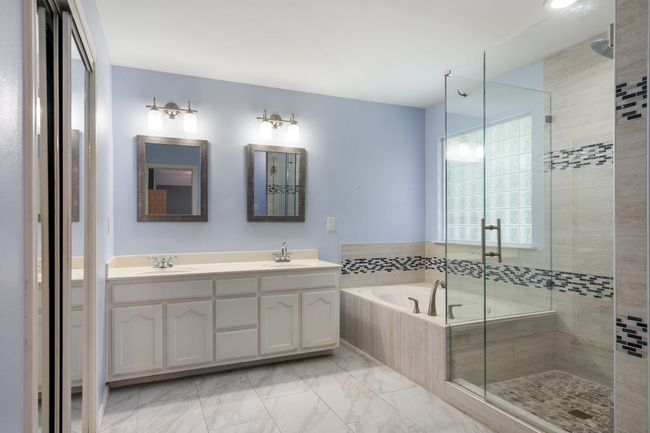 Bathroom featuring a sink, a shower stall, and a garden tub | Image 25