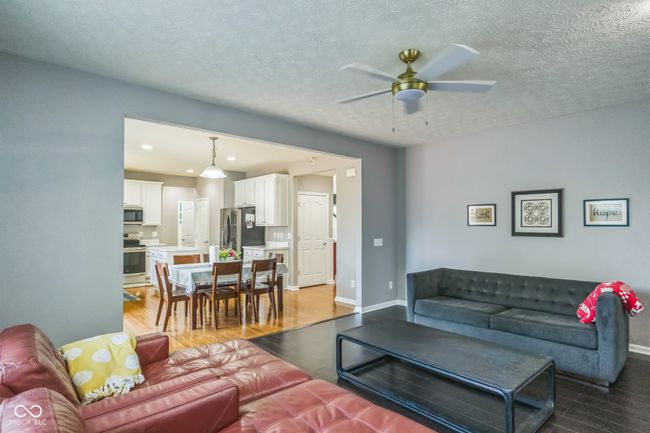 living area with ceiling fan, wood finished floors, recessed lighting, and a textured ceiling | Image 7