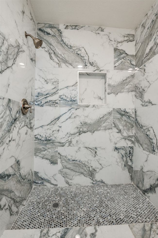 Detailed view of a marble finish shower | Image 15