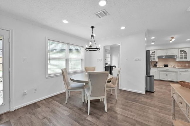 Double pane windows provide a great view of the Back Yard. This area also has an updated light fixture and faux wood blinds when you desire more privacy. | Image 9