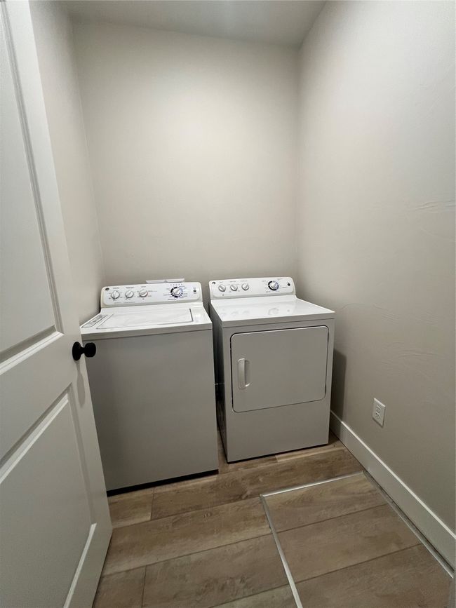 Washroom with washer and dryer, wood finished floors, and baseboards | Image 19