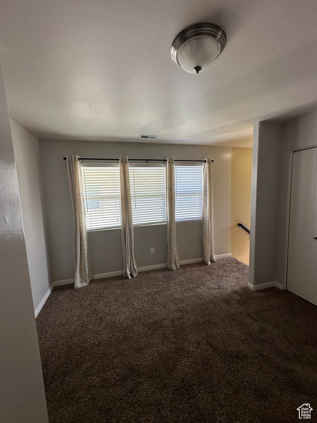 Unfurnished room featuring a wealth of natural light, carpet floors, visible vents, and baseboards | Image 11