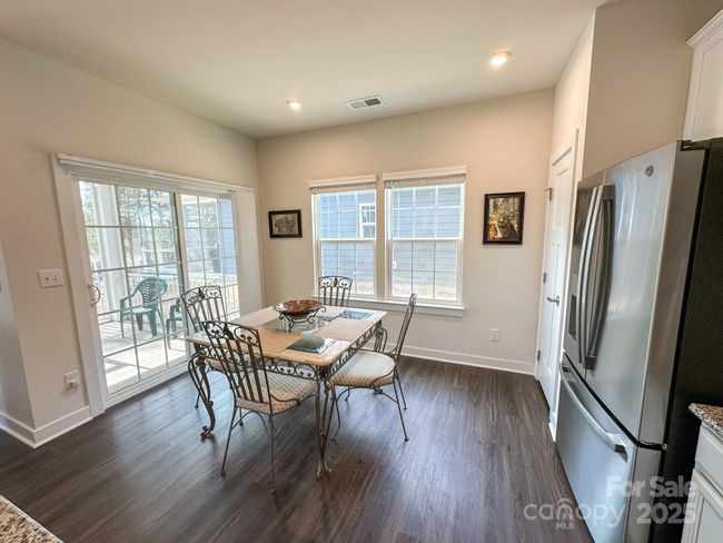 Dining area overlooking covered back patio. | Image 9