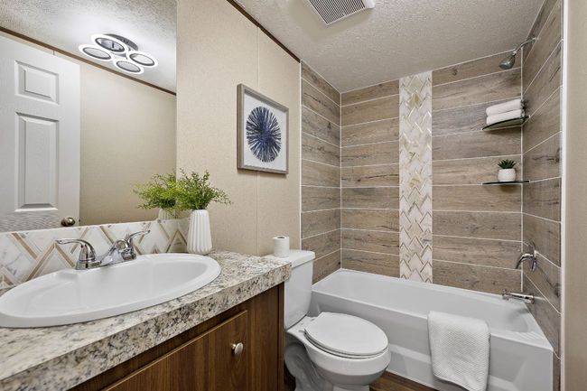 Full bathroom with visible vents, a textured ceiling, vanity, and toilet | Image 30