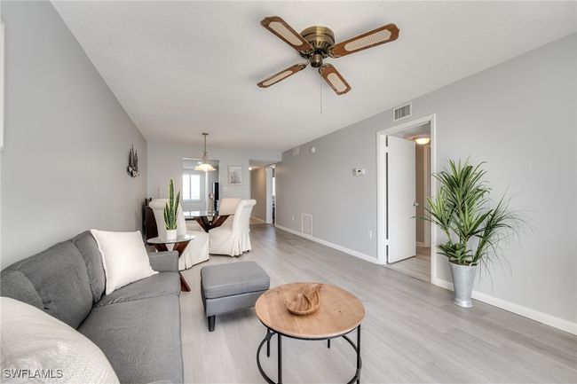 Living room featuring ceiling fan and light hardwood / wood-style floors | Image 23