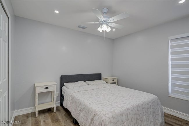 Bedroom with wood finished floors, baseboards, recessed lighting, and ceiling fan | Image 14