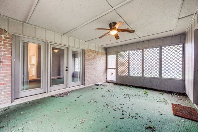 Unfurnished sunroom featuring a ceiling fan | Image 20