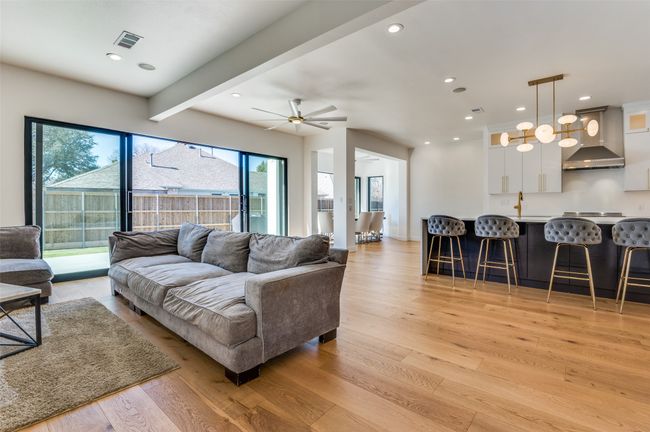 Living room featuring visible vents, beamed ceiling, light wood-style floors, ceiling fan, and recessed lighting | Image 21
