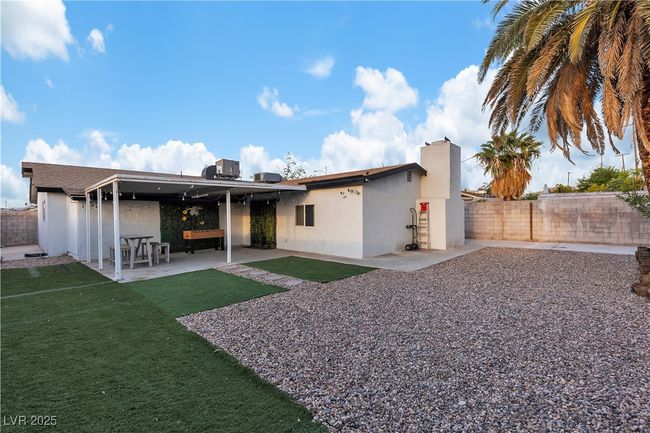 Back of house with a patio, a fenced backyard, stucco siding, and a lawn | Image 42