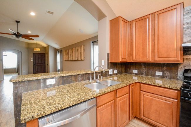 Wide granite countertops provide space for cooking. | Image 10